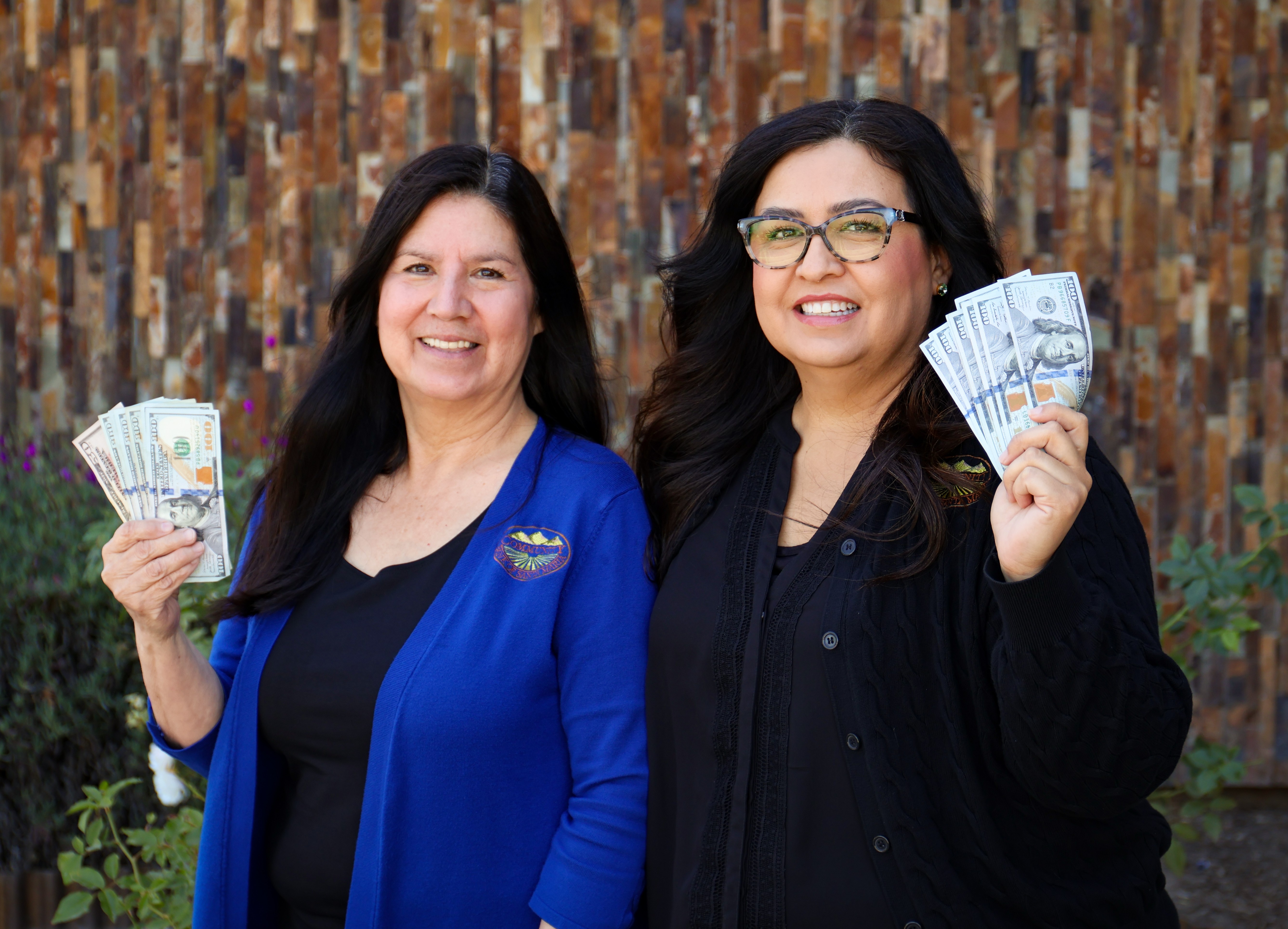 Photo of employees holding various items
